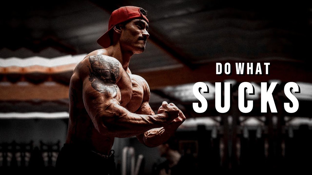 YouTube post by @MuscleBrawn for ENHANCED Labs. Caption reads: DO WHAT SUCKS 😕 Gym Motivation.