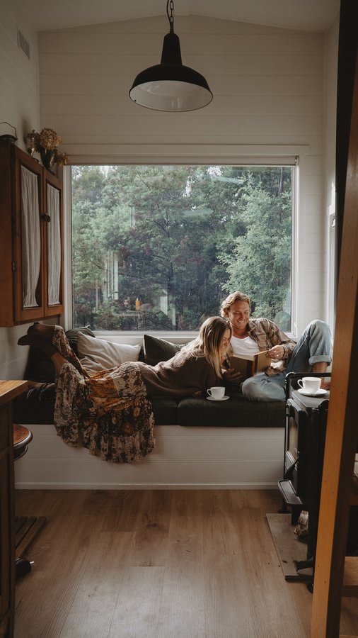 Instagram post by @justmetay_ for Journi. Caption reads: Cosy Tiny House vibes in Tassie, flipping through....