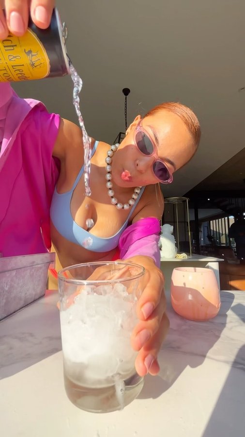 Instagram post by @uhcaitlin for Cotton On Body. Caption reads: DJ Chomzalaaaaa 🤣🤸🏽‍♀️💖🏄🏽‍♀️🌈💦 on the....