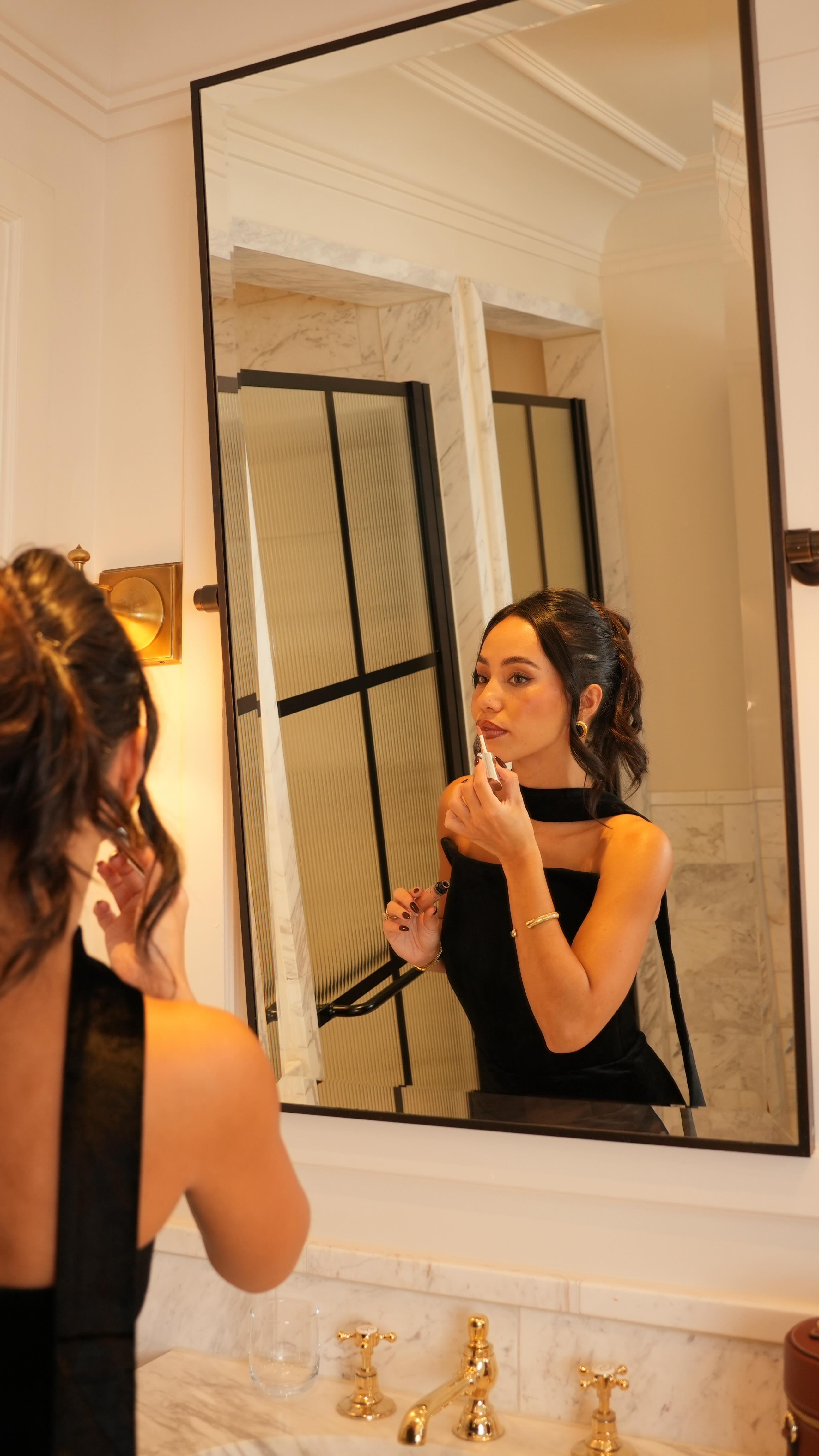 Instagram post by @ooliviamiller for Nadine Merabi. Caption reads: ad Can we all agree that getting ready is half the....