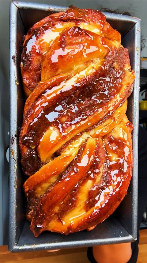 Instagram post by @carolinagelen for NYT Cooking. Caption reads: DATE CARAMEL BABKA — a rich, buttery sweet bread....