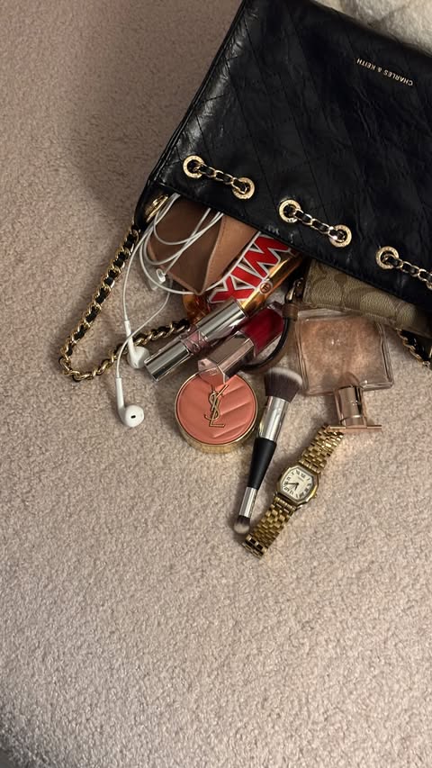 Instagram post by @allthingsglamwithnikita for Fossil. Caption reads: what’s in my bag 🧳 #pr #beautycreatorclub....