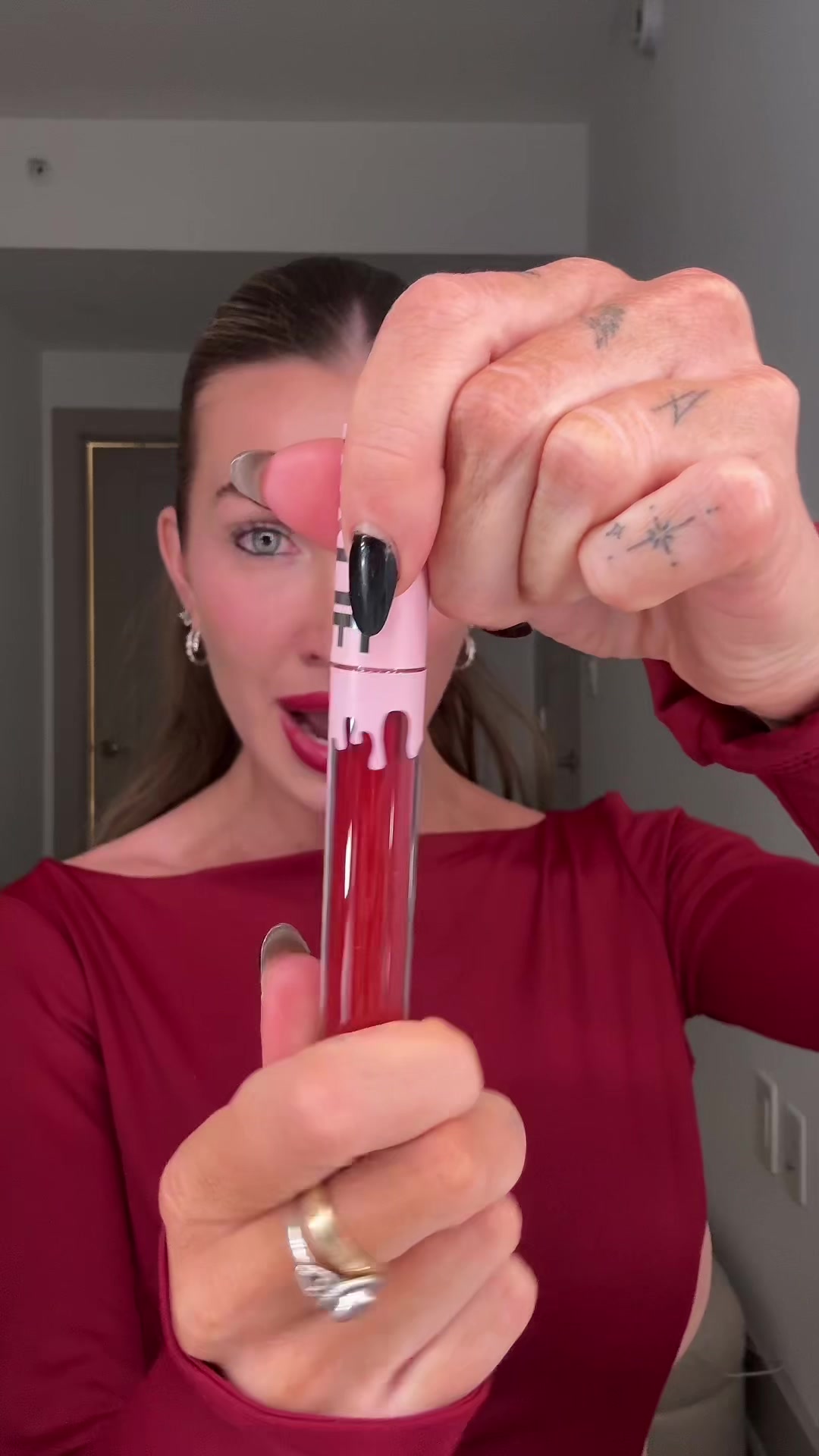 TikTok post by @kateecass for Kylie Cosmetics. Caption reads: I’m in love with a red lip for the holidays....