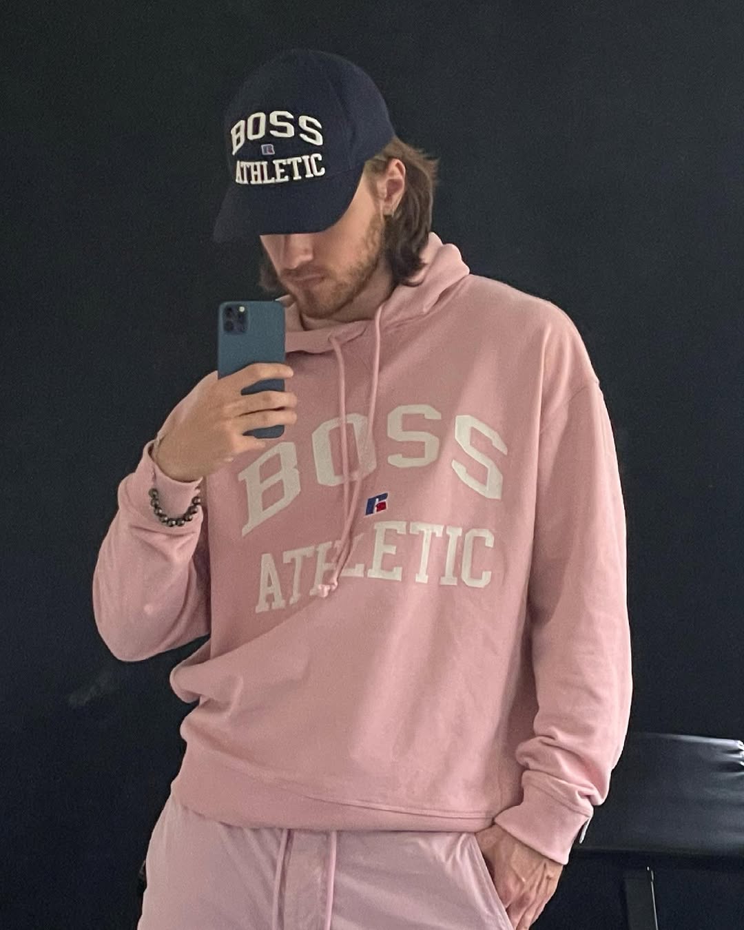 Instagram post by @maciejmusial_official for Russell Athletic. Caption reads: The hoodie says @boss but you can call me daddy ....
