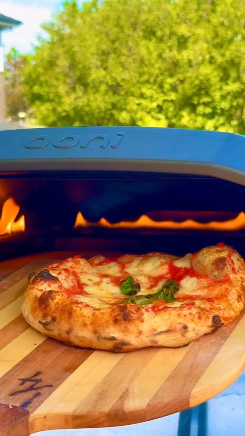 Instagram post by @theoneeighthitalian for Ooni. Caption reads: [...] pizza snack Dough size: 150g Baked in the....