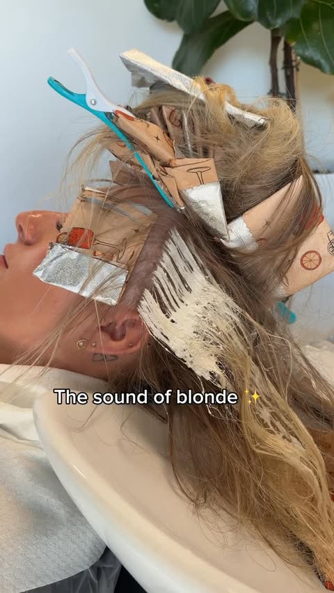 Instagram post by @hair_by_oana for Moroccanoil. Caption reads: [...] 🤓 For this look, I used Moroccanoil Blonde....