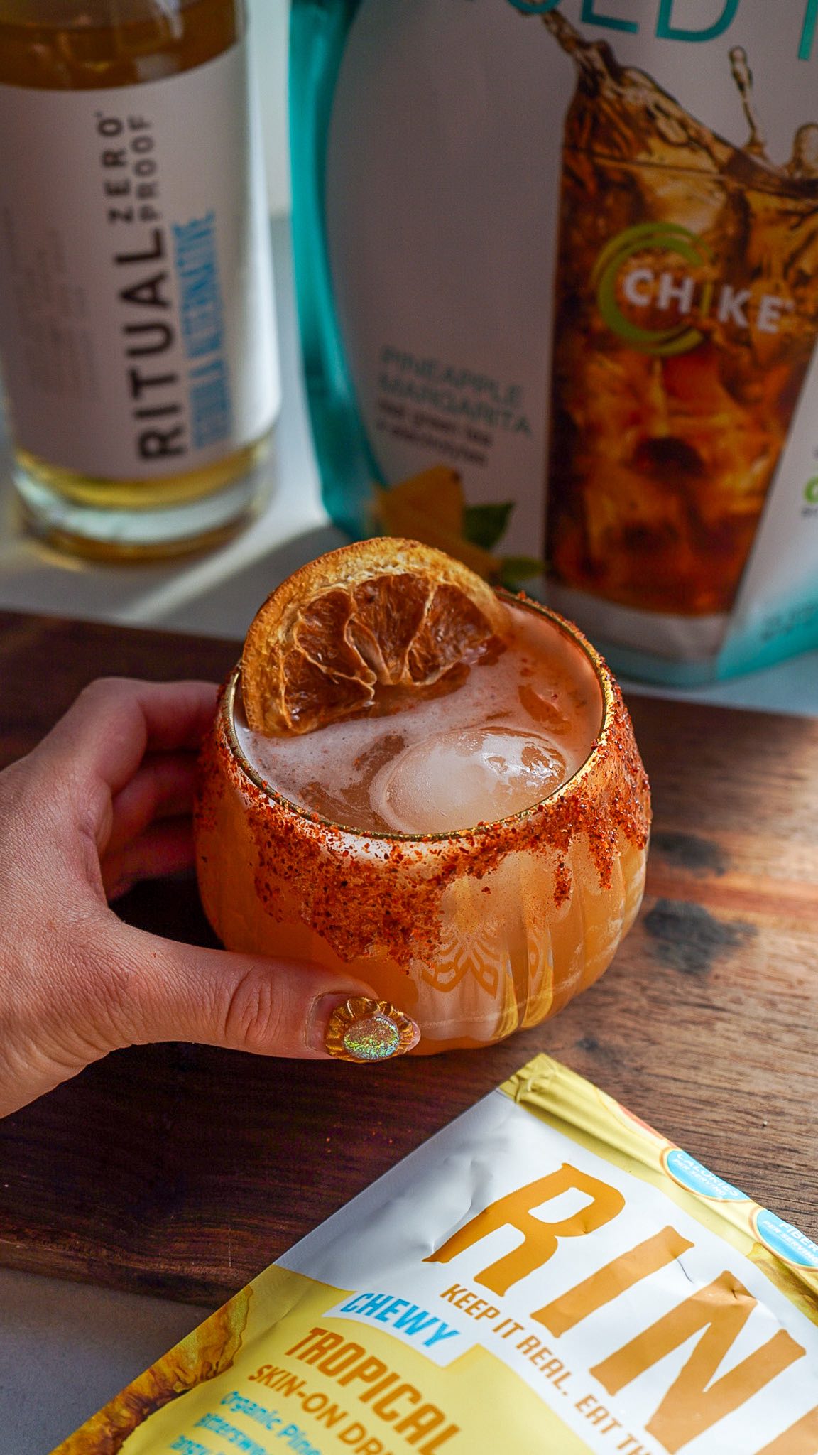 Instagram post by @purely_healthy_living for RIND Snacks. Caption reads: 🌶️🍍 Cinco de Mayo just got a refreshing twist 💃....