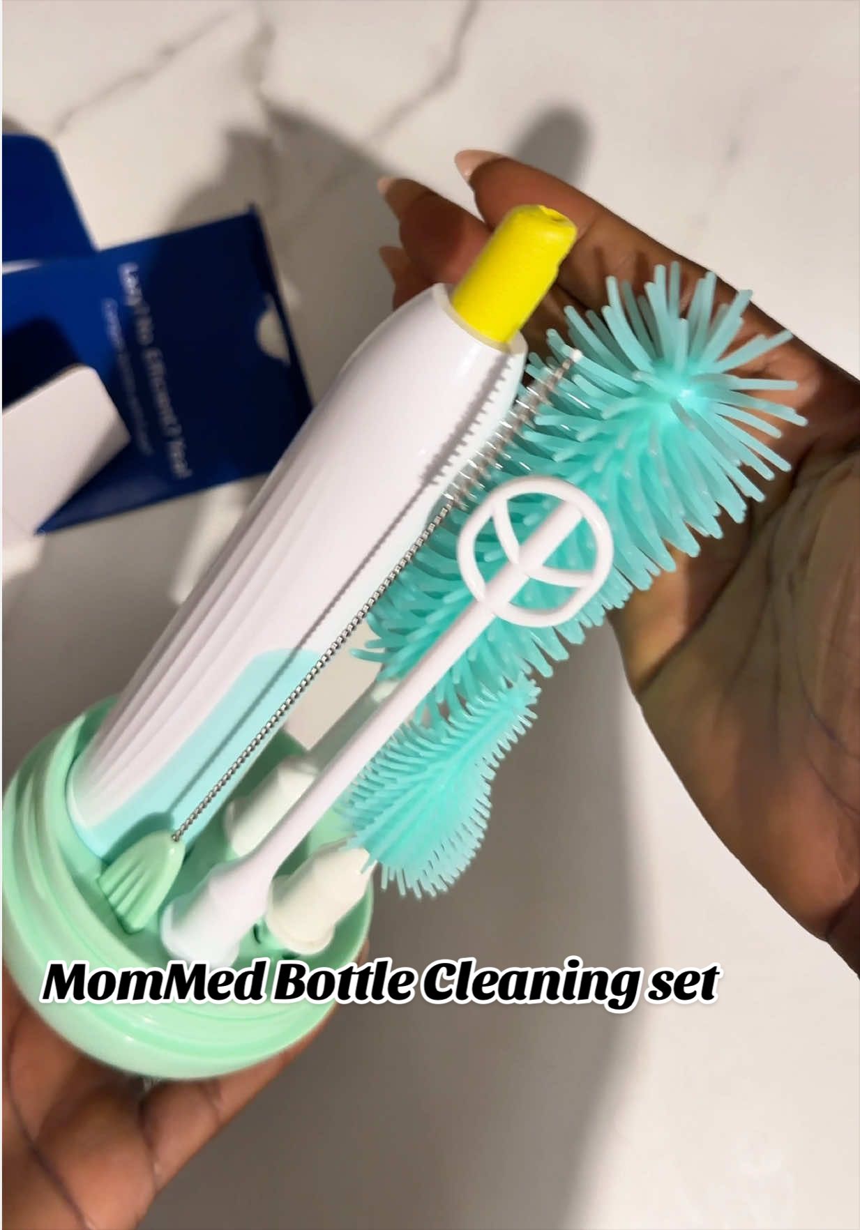 TikTok post by @precious_wiginflencer for Mommed. Caption reads: [...] this Makes cleaning bottles 10x easier....
