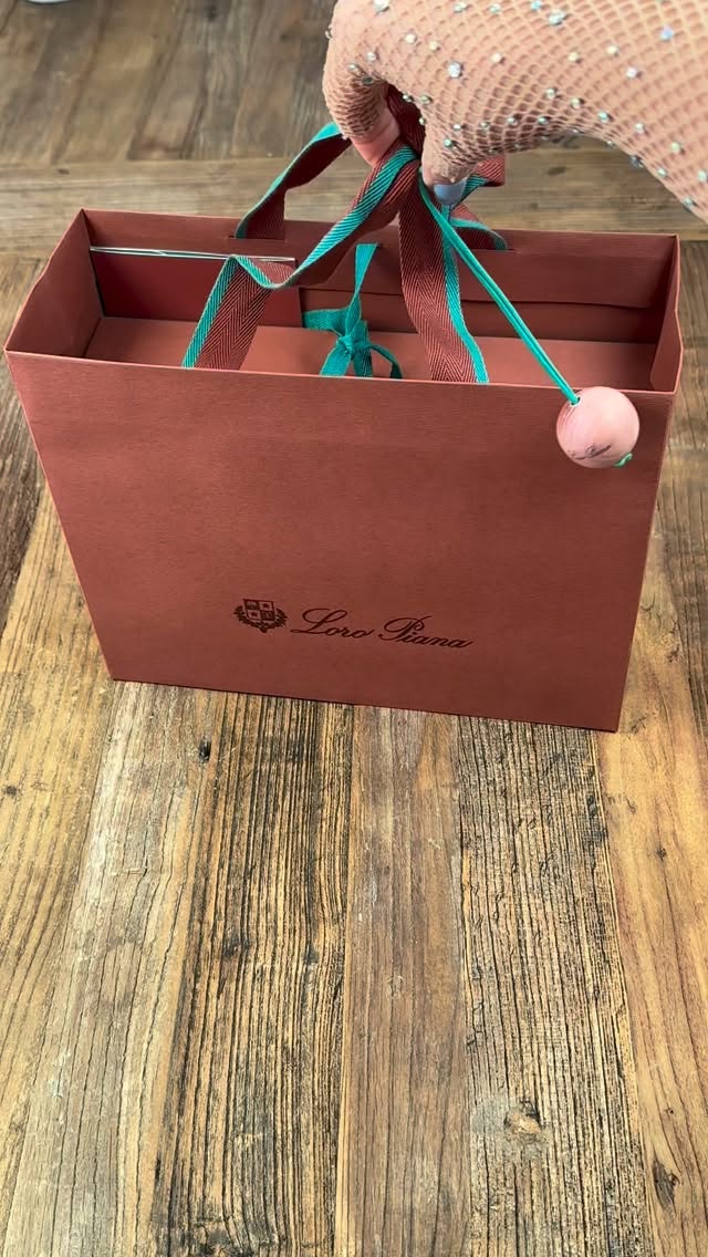 Instagram post by @hodaglamm for Loro Piana. Caption reads: Fall shoe unboxing!🤎🤎🤎
@loropiana Summerwalk....