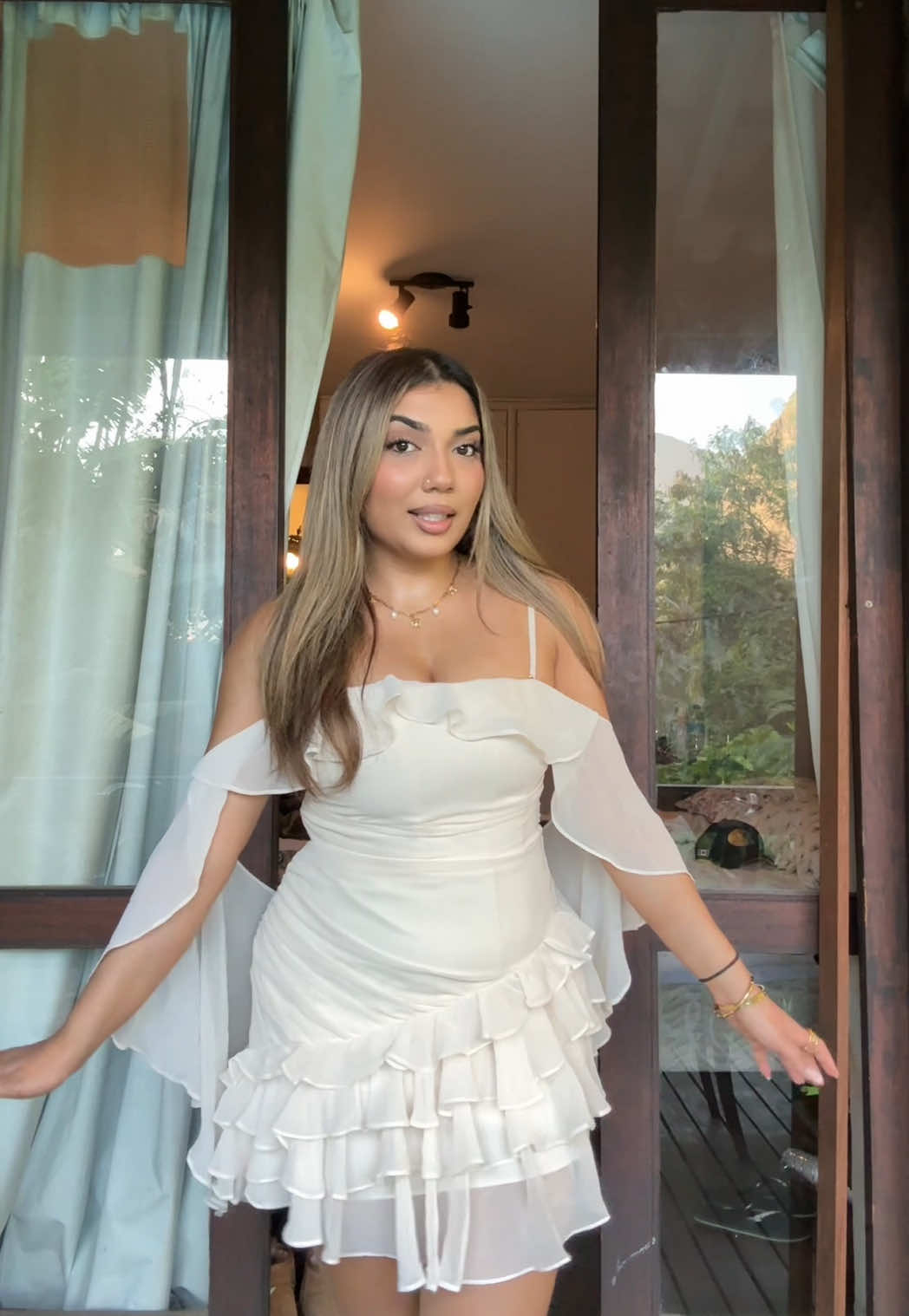 TikTok post by @kajalxo_ for OH POLLY. Caption reads: grwm for nye in brazil!!!  dress @Oh Polly ....