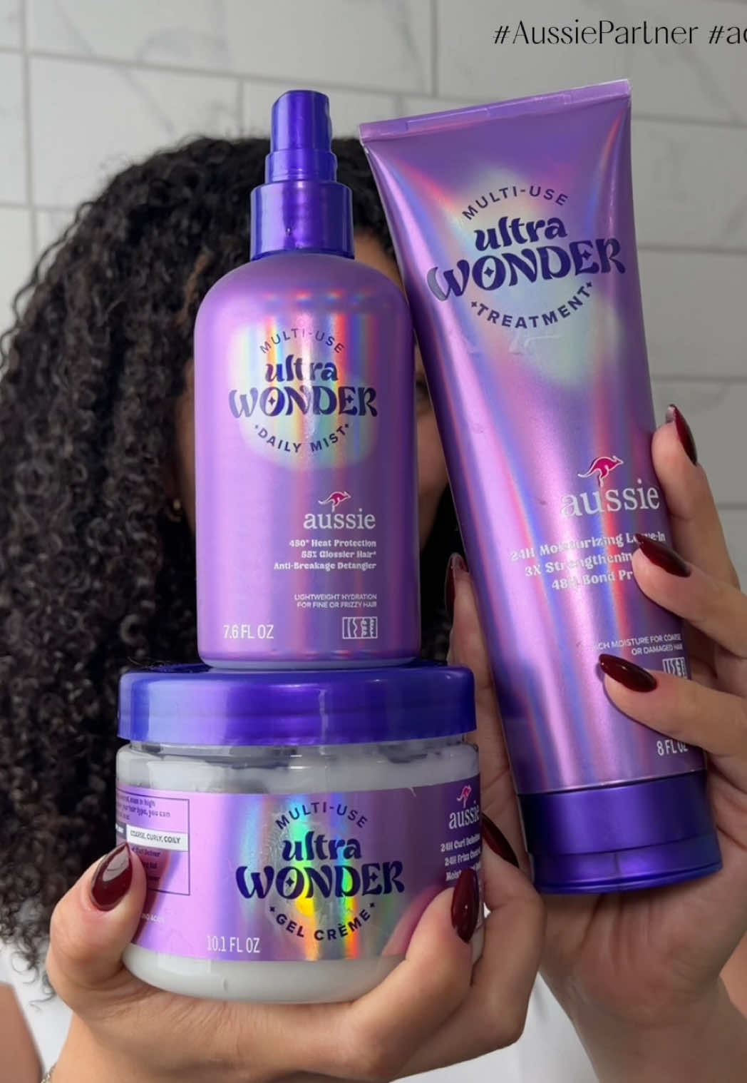 TikTok post by @curlelia for Aussie Hair. Caption reads: [...] #aussiepartner Daring to Wonder with @Aussie....