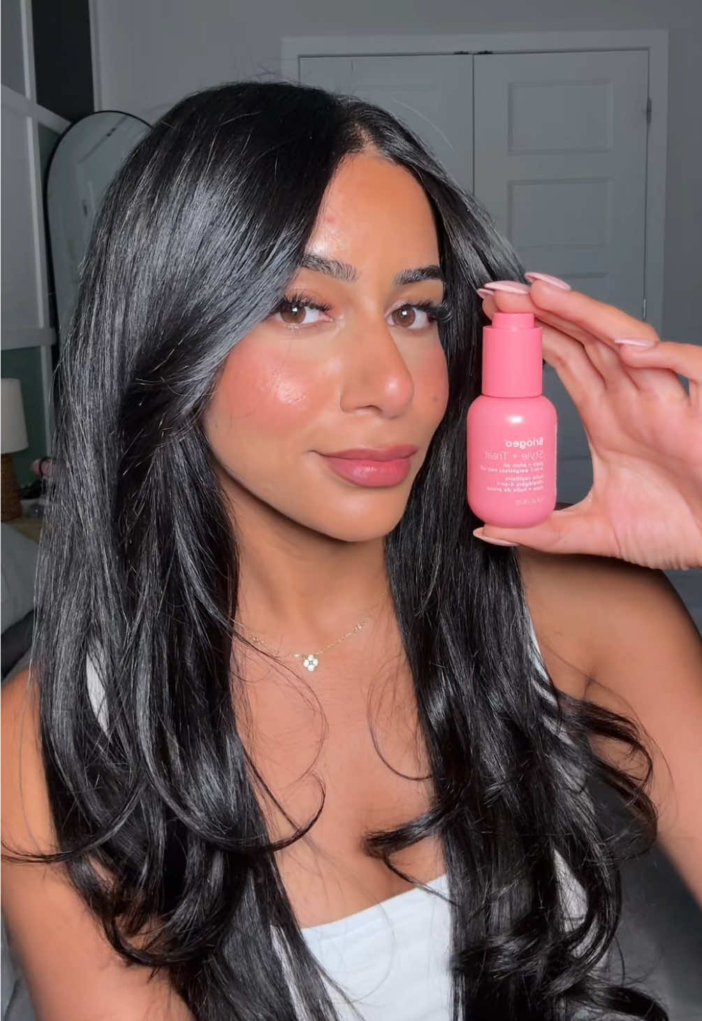 TikTok post by @itsdeepie for Briogeo. Caption reads: [...] shiny hair is in this cute pink bottle:....