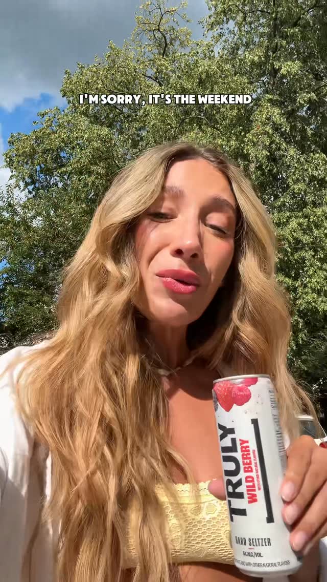 Instagram post by @kaylamichellefisher for Truly Hard Seltzer. Caption reads: [...] and join me?🌞🌊 @truly #trulyszn....