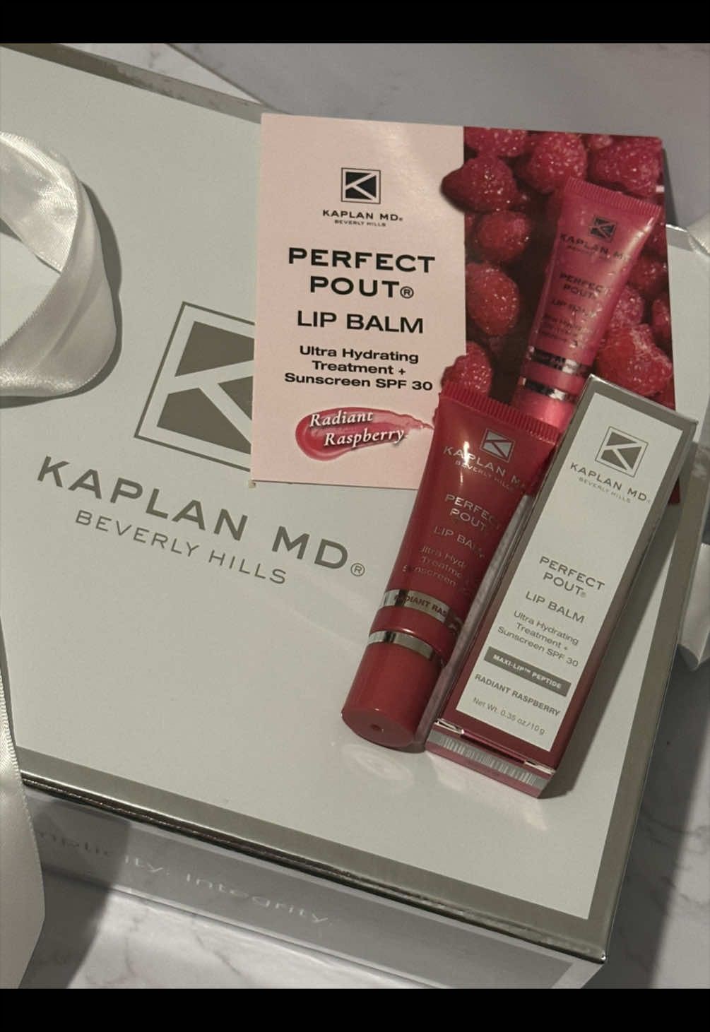 TikTok post by @chit_club for KAPLAN MD. Caption reads: Unboxing luxury PR mail with @KAPLAN MD BEVERLY....