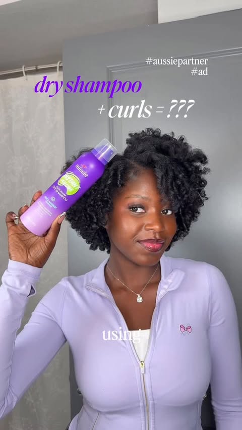 Instagram post by @celestialjojo for Aussie Hair. Caption reads: [...] big hair for the win 🥳💜#curlsgirls....