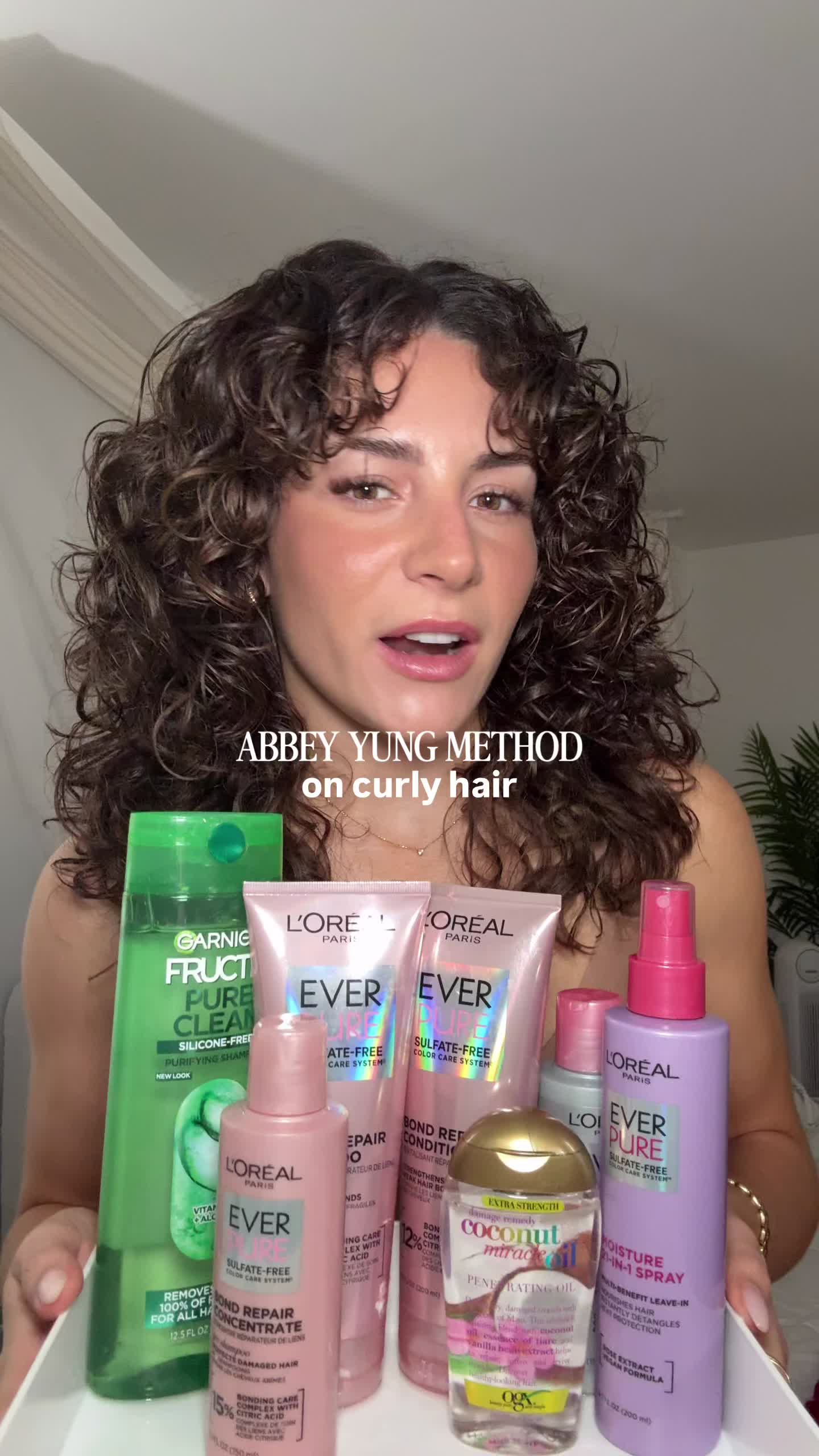 TikTok post by @itsmarinaann for OGX Beauty. Caption reads: [...] @L’Oreal Paris Makeup & Hair @Garnier USA....