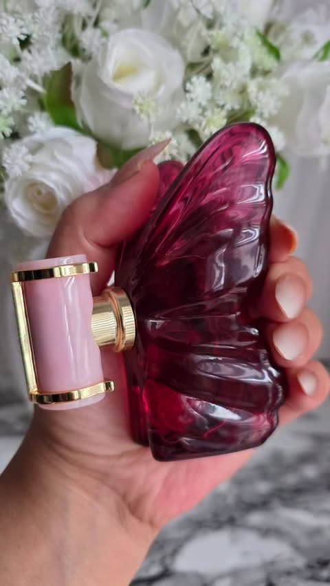Instagram post by @madame_keke for CAROLINA HERRERA. Caption reads: [...] that lingers like silk on skin.....