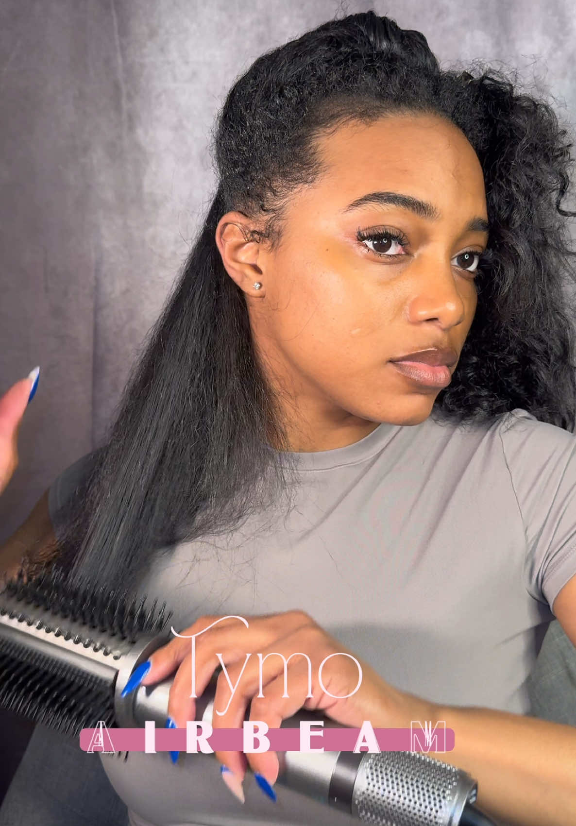 TikTok post by @butimbria for TYMO Beauty. Caption reads: [...] I want big fluffy curls 🩶 @TYMO BEAUTY US....