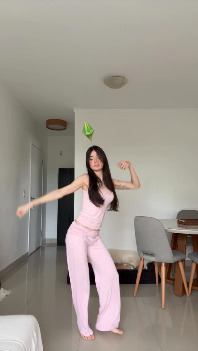 Instagram post by @vidcg for The Sims. Caption reads: @thesims 💚 #thesimscostume #thesimsdance #thesims.