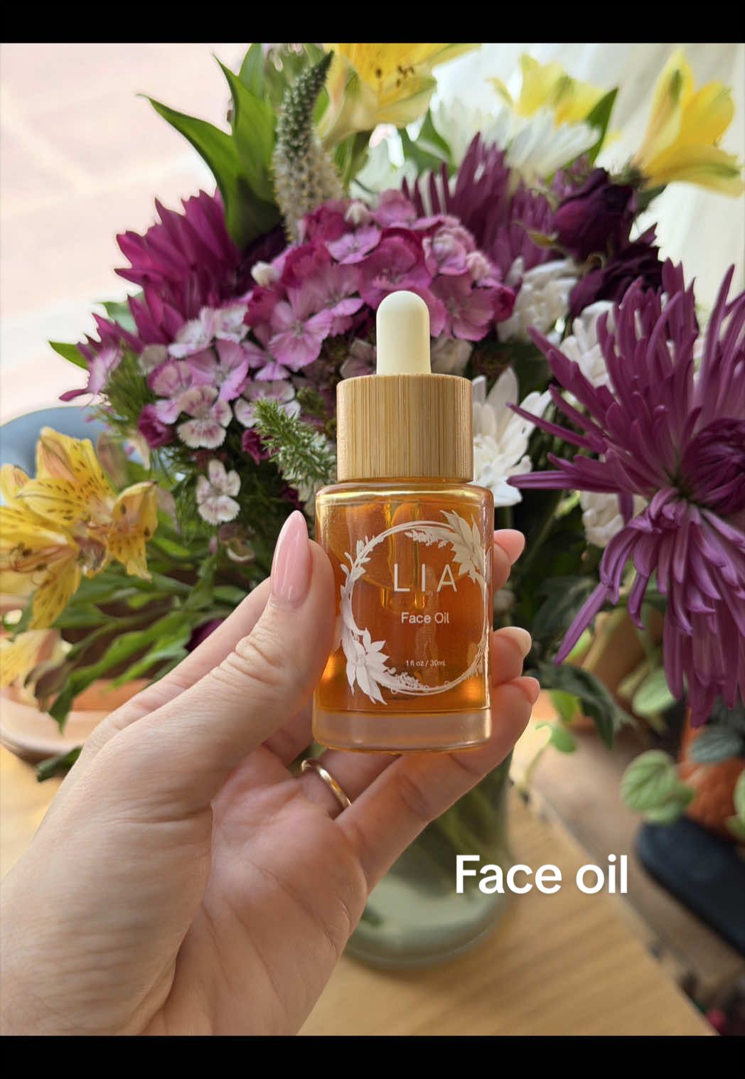 TikTok post by @katiemarie.ugc.creator for LIA Organics. Caption reads: [...] has been loving this face oil from @LIA....