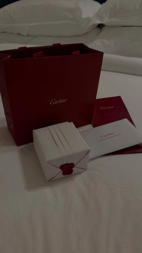 Instagram post by @katrinkaa.k for Cartier. Caption reads: Luxury unboxing in a hotel 💍.