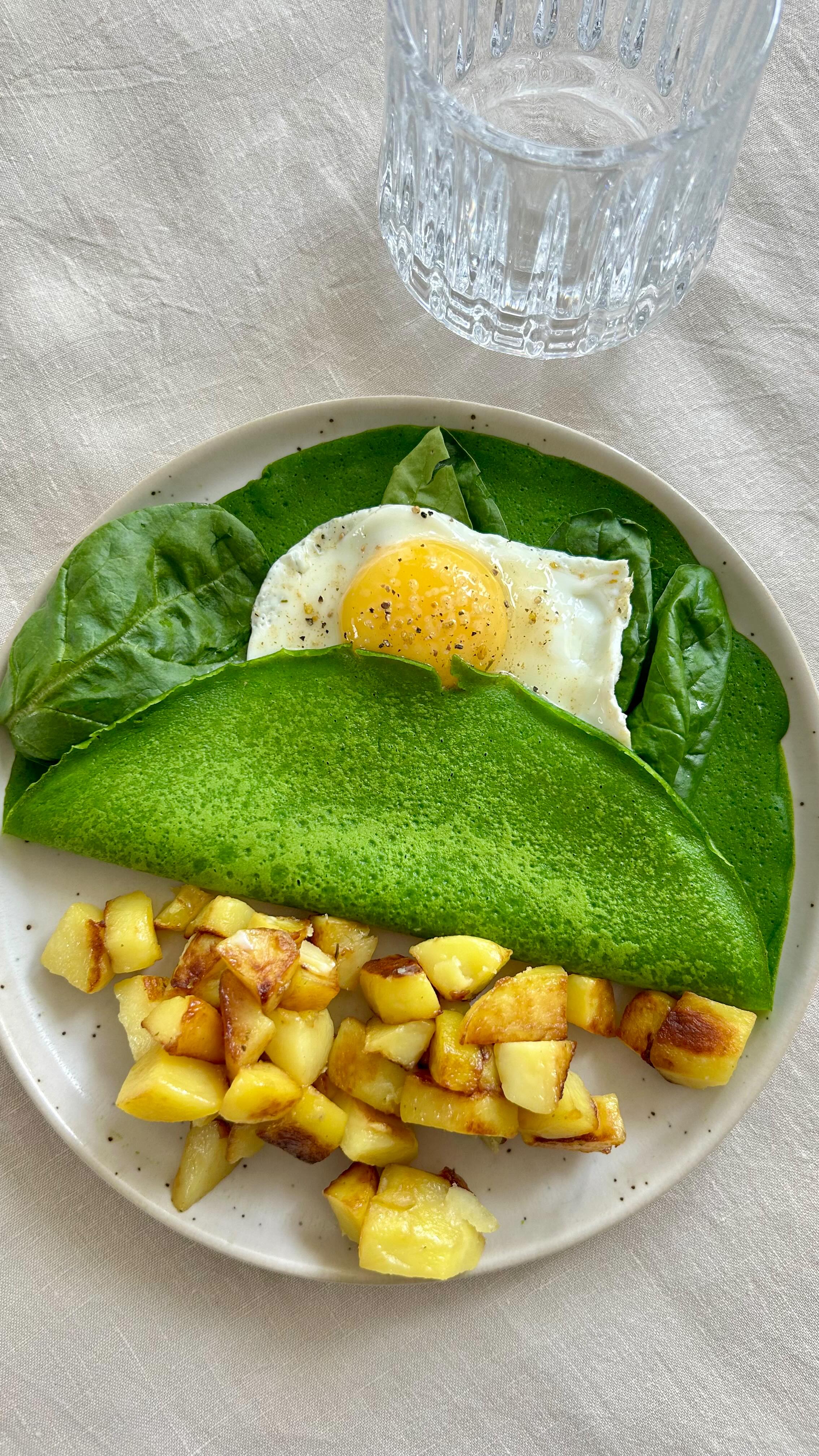Instagram post by @celinemarks for from Our Place. Caption reads: 🌿LUNCH SPINACH CREPES 🌿 INGRÉDIENTS : - 180 ml....