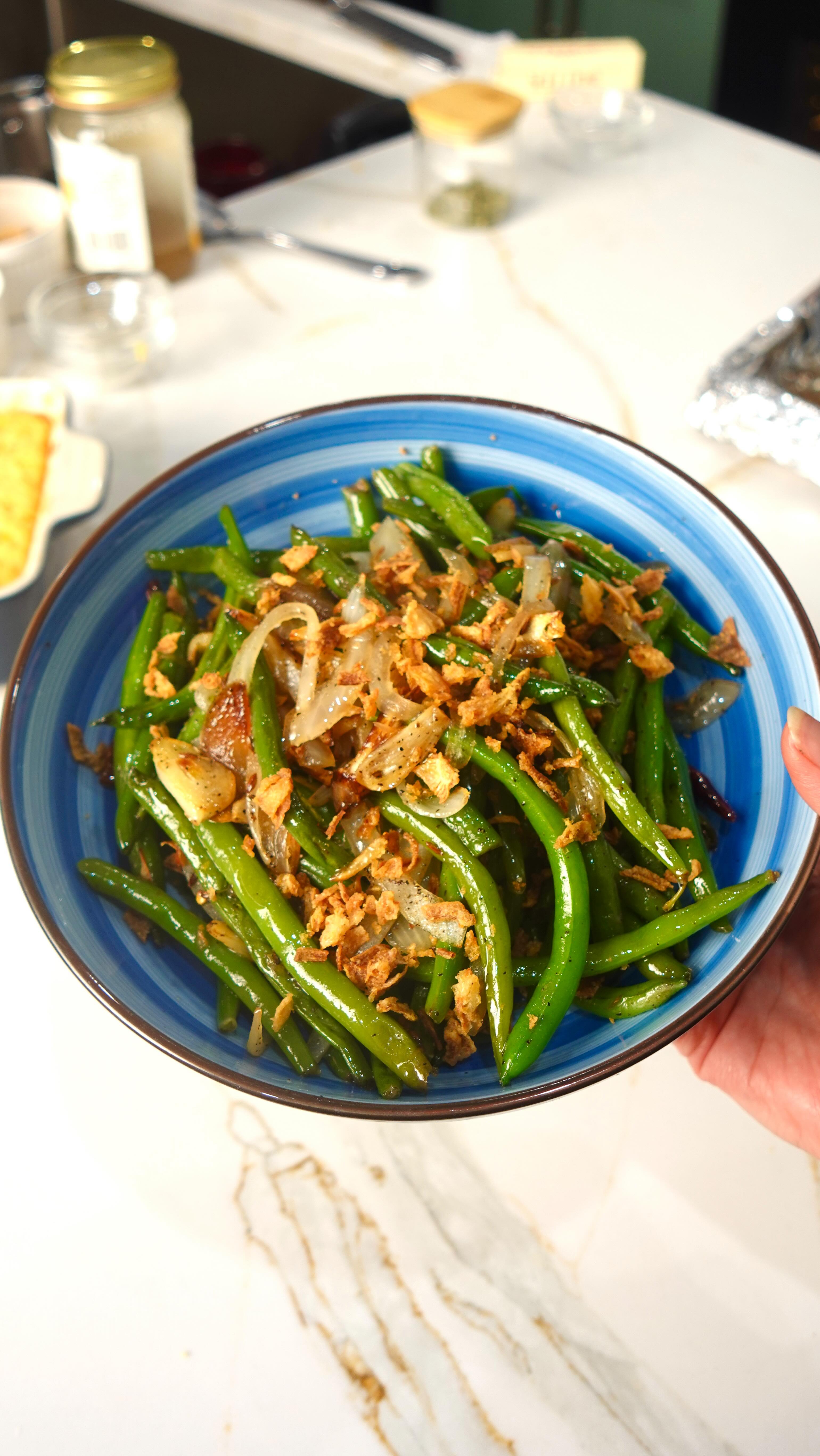 Instagram post by @shompsz for Food52. Caption reads: ✨crispy green beans with onion tharka 

So simple....