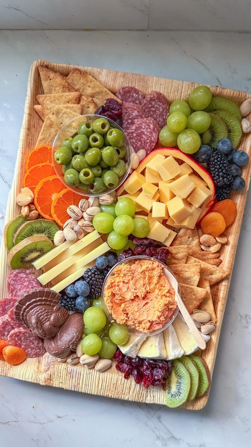 Instagram post by @charcuterie_n_things for Simple Mills. Caption reads: Build a FRIENDSGIVING board with me!

✨ Cheeses:....