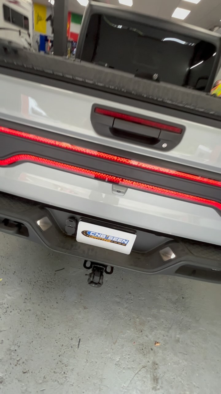 Instagram post by @cnbseenupfitting for ORACLE Lighting. Caption reads: Racetrack, taillights and lower bumper reverse....