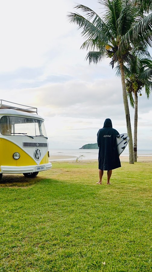 Instagram post by @robkellysurf for dryrobe. Caption reads: Surfing has taken me to places around the world I....
