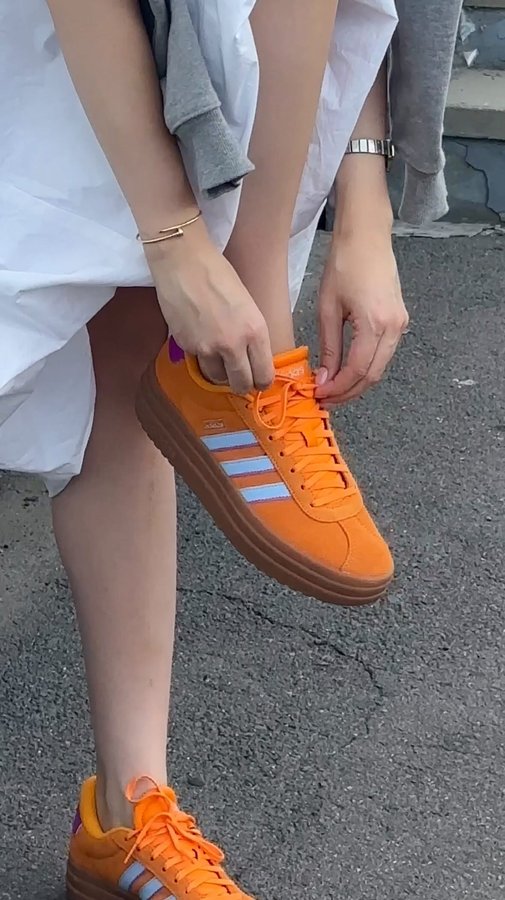 Instagram post by @adagoiu for CCC. Caption reads: [...] The New Orange Adidas Sneakers🍊👟....