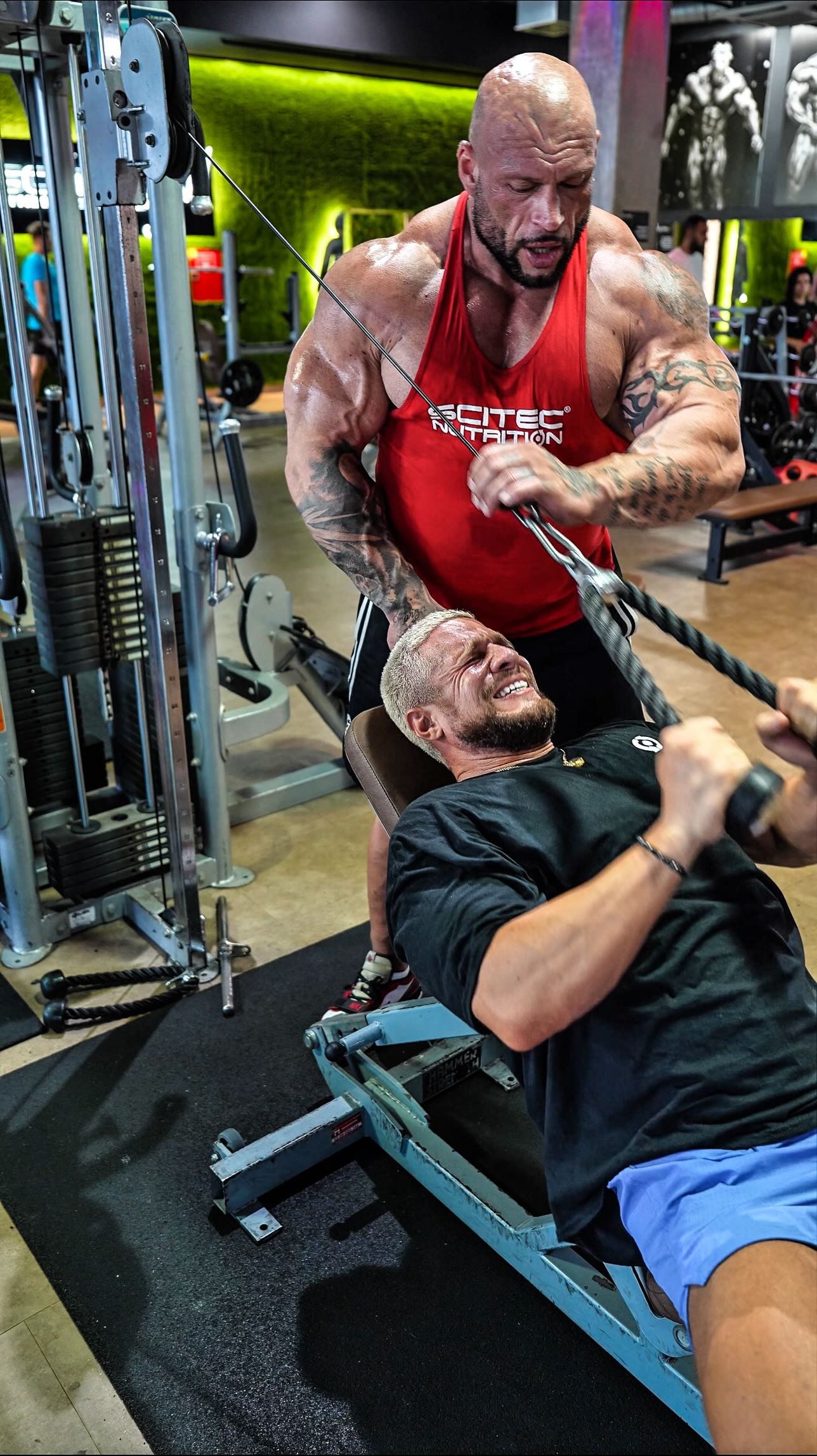 Instagram post by @sebastian_maschberger for Scitec Nutrition. Caption reads: IT HITS DIFFERENT: Incline Cable Tricep Pushdown....