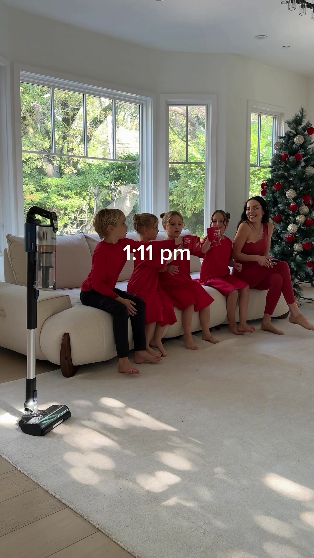 TikTok post by @annatwinsies for Levoit. Caption reads: ASMR MOM CHRISTMAS TREE DECORATING AND CLEANING....