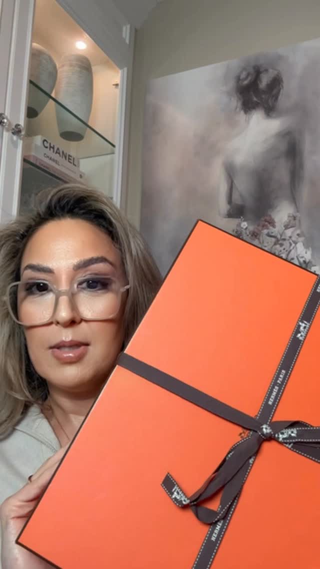 Instagram post by @hodaglamm for Hermès. Caption reads: Hermes unboxing🧡 #hermes....