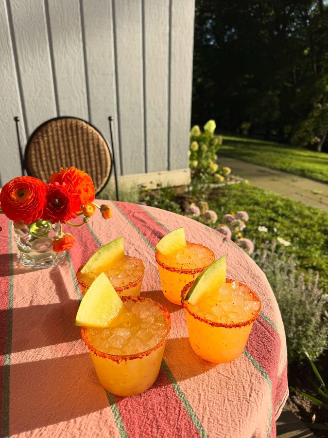 Instagram post by @justines.table for Cointreau. Caption reads: SALTED YELLOW WATERMELON MARGS with cucumber and....