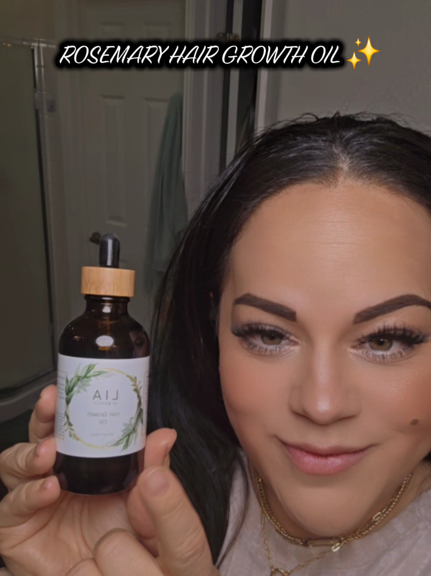 TikTok post by @momofthree100 for LIA Organics. Caption reads: LIA ORGANICS ROSEMARY HAIR GROWTH OIL ✨️ CLEAN....