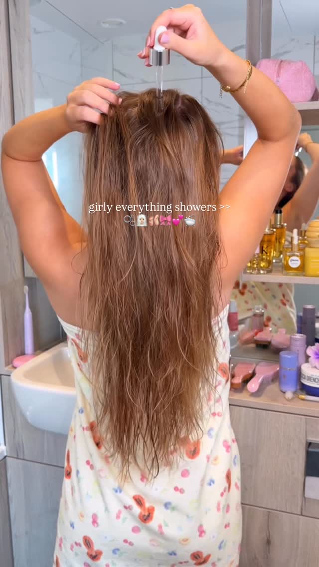 Instagram post by @byemmaleah for OUAI. Caption reads: girly everything shower nights >>....