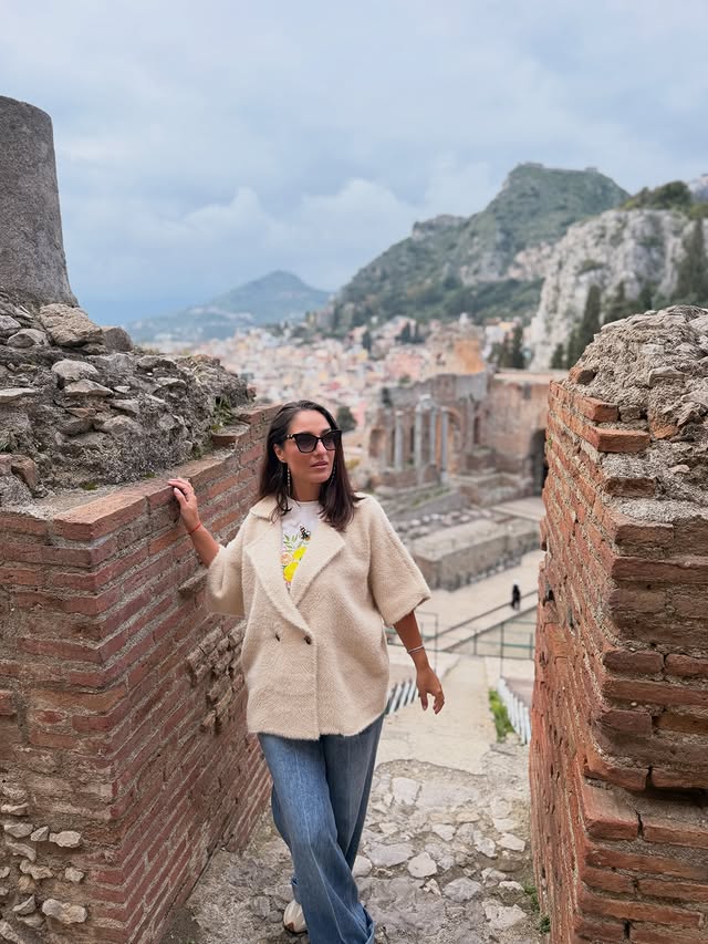 Instagram post by @alexandra_boharu for Bonprix. Caption reads: Some places are just magical⚜️ 🧥 & 👖: @bonprix....