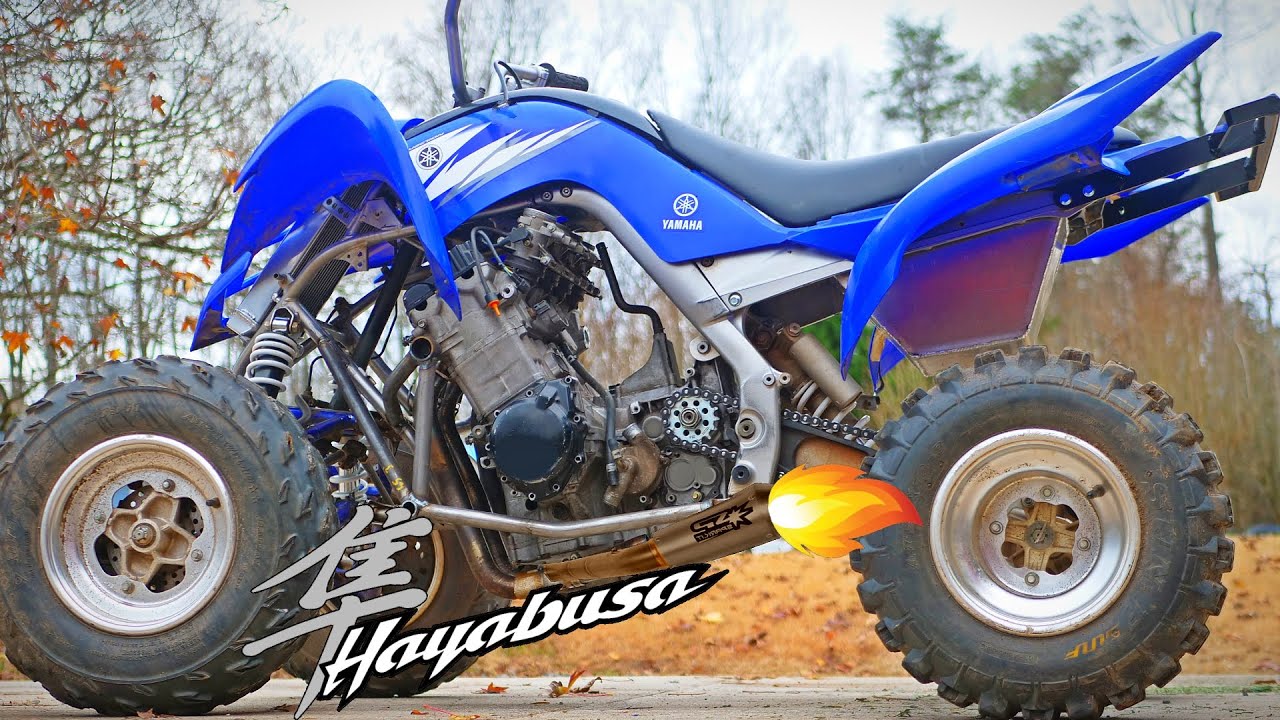 YouTube post by @VasilyBuilds for Benchmark Abrasives. Caption reads: 1300cc Hayabusa in my raptor 700r quad part 1.