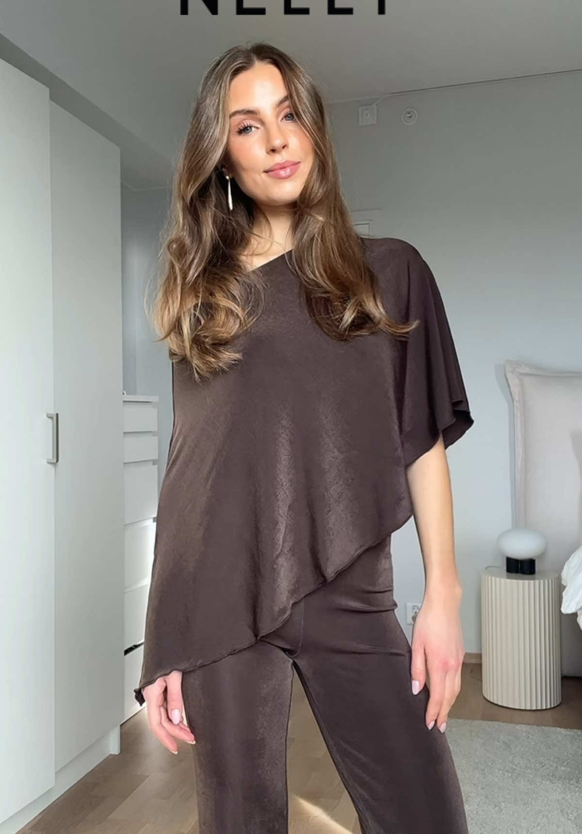 TikTok post by @celinetysnes for Nelly. Caption reads: Ad | @NELLY.COM | Outfits for this season’s [...].