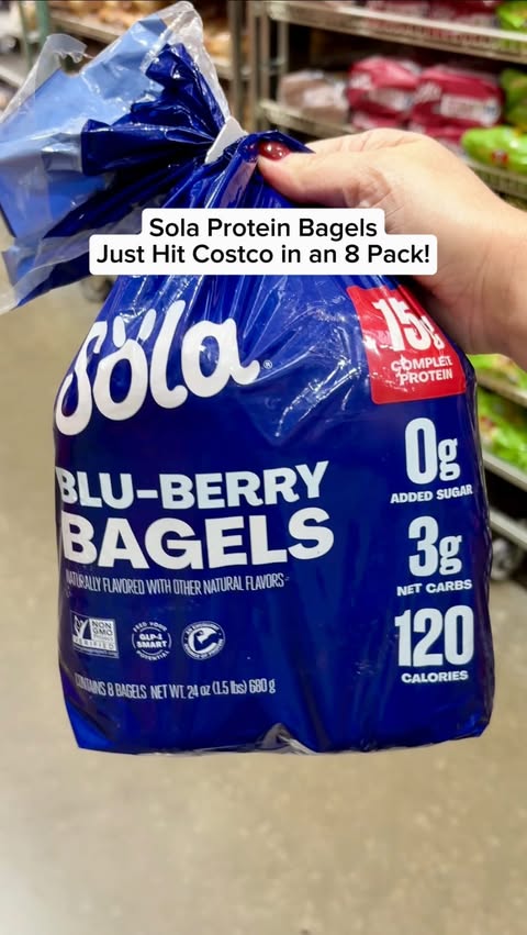 Instagram post by @grocery_obsessed for The Sola Company. Caption reads: Sola Blu-Berry Protein Bagels just hit @Costco in....