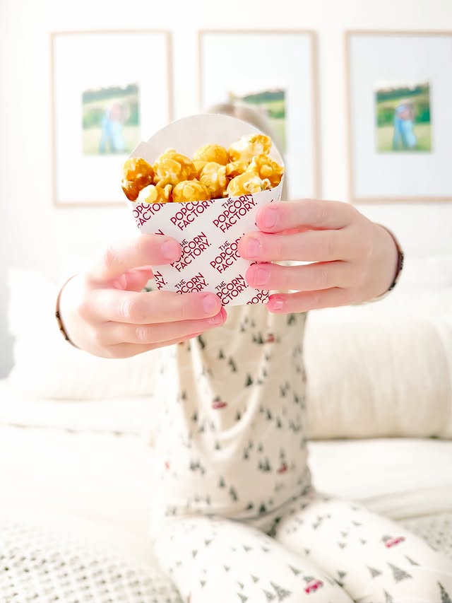 Instagram post by @madissonstickel for The Popcorn Factory. Caption reads: The Christmas traditions are POPPING over here! 🍿....