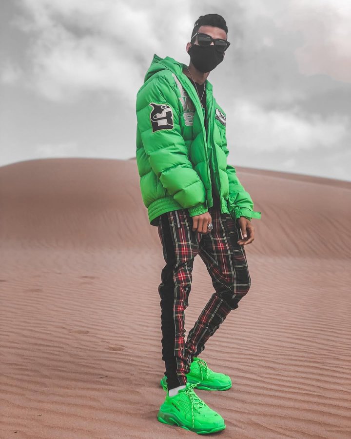 Instagram post by @itsmeanoir for MarsQuest. Caption reads: Green lighting in barren sands 🍀🏝. Pants by....