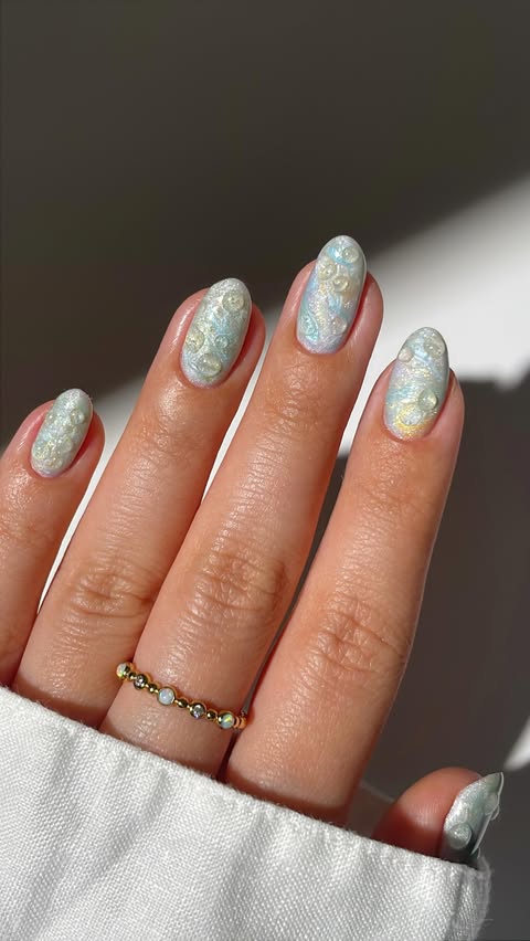 Instagram post by an influencer for MYLEE | AT-HOME GEL NAILS. Caption reads: ad • spring marble nails with water drops🥹💛🫧🌼....