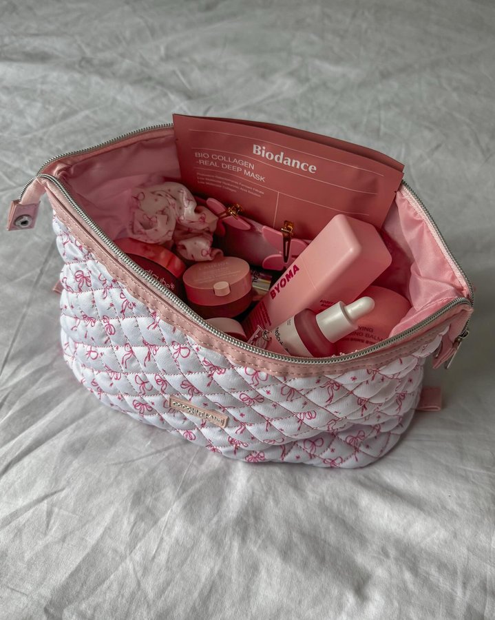 Instagram post by @nikitourliadou for Coconut Lane. Caption reads: 💕Packing all my pink skincare into my....