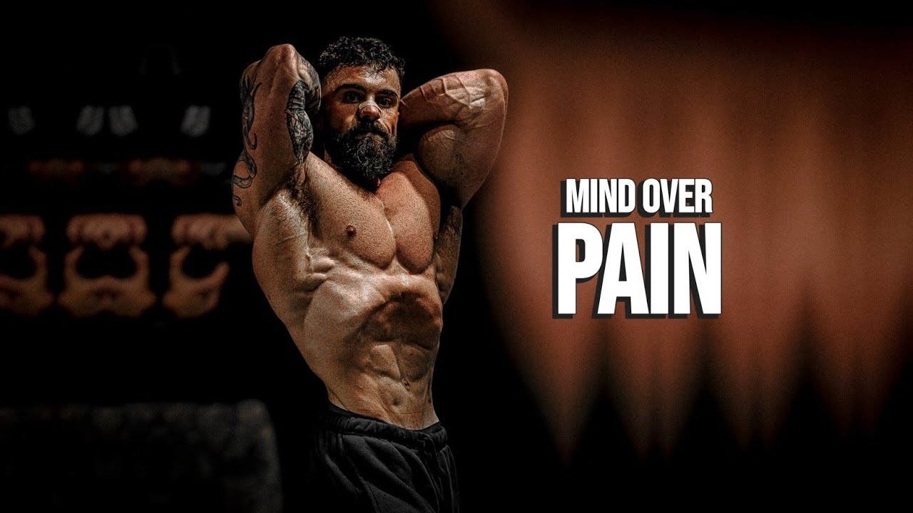YouTube post by @MuscleBrawn for ENHANCED Labs. Caption reads: MIND OVER PAIN 😈 Gym Motivation.