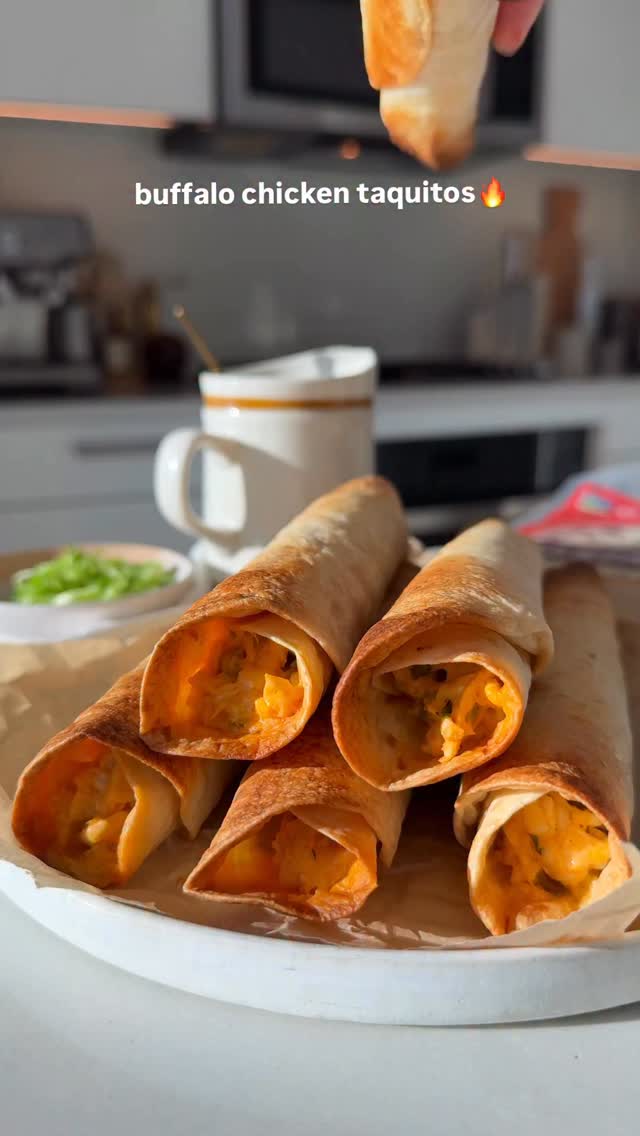 Instagram post by @munchinwithmaddie_ for Whole Foods Market. Caption reads: crispy baked buffalo chicken taquitos for all your....