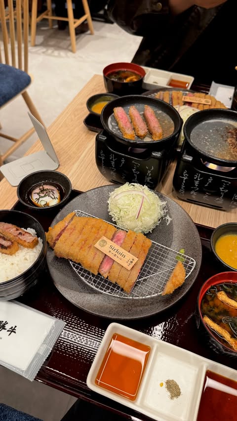 Instagram post by @angiefeasts for Gyukatsu Kyoto Katsugyu. Caption reads: [...] amount of sweetness! [invite💌]....