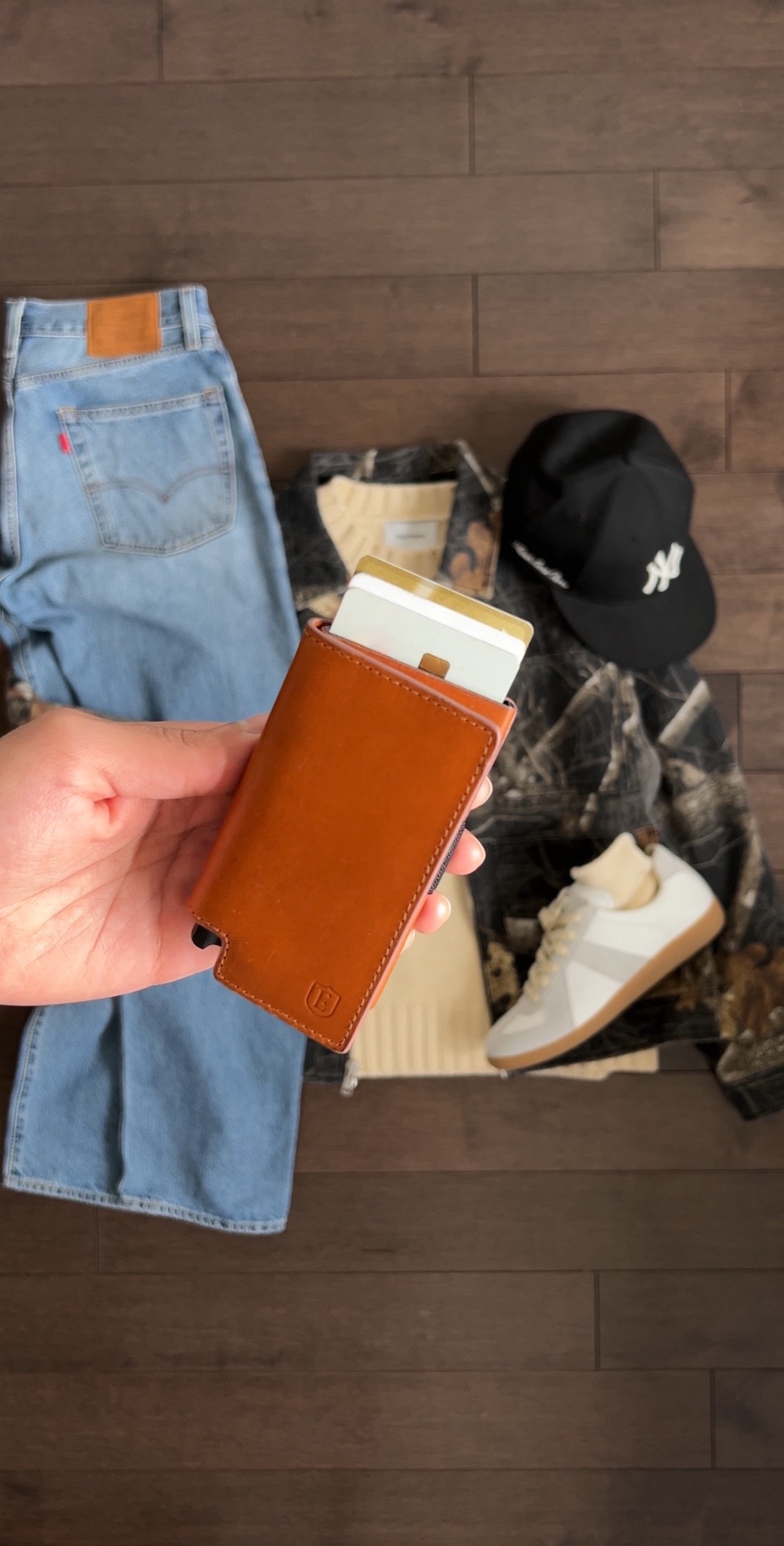 TikTok post by @omgessin for Ekster. Caption reads: simple outfits with my new wallets from @Ekster®,....