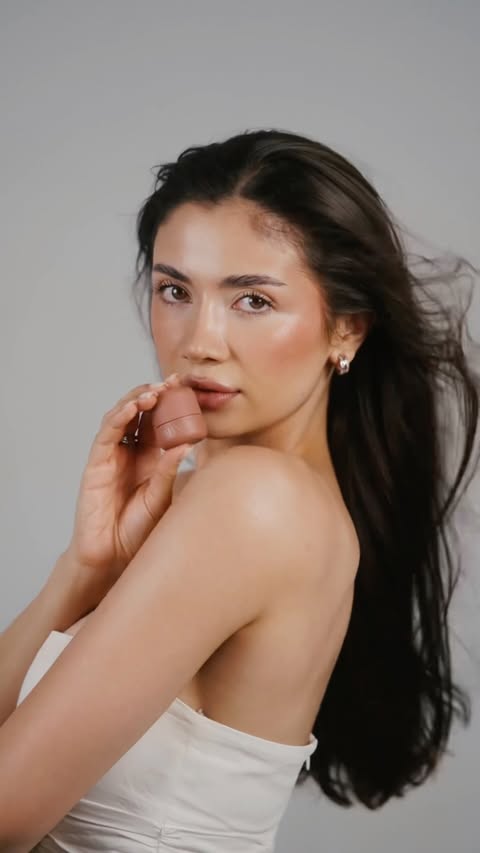Instagram post by @laurentiabruma for Douglas Cosmetics. Caption reads: From hair rollers to rosy cheeks with Armani Dolci....